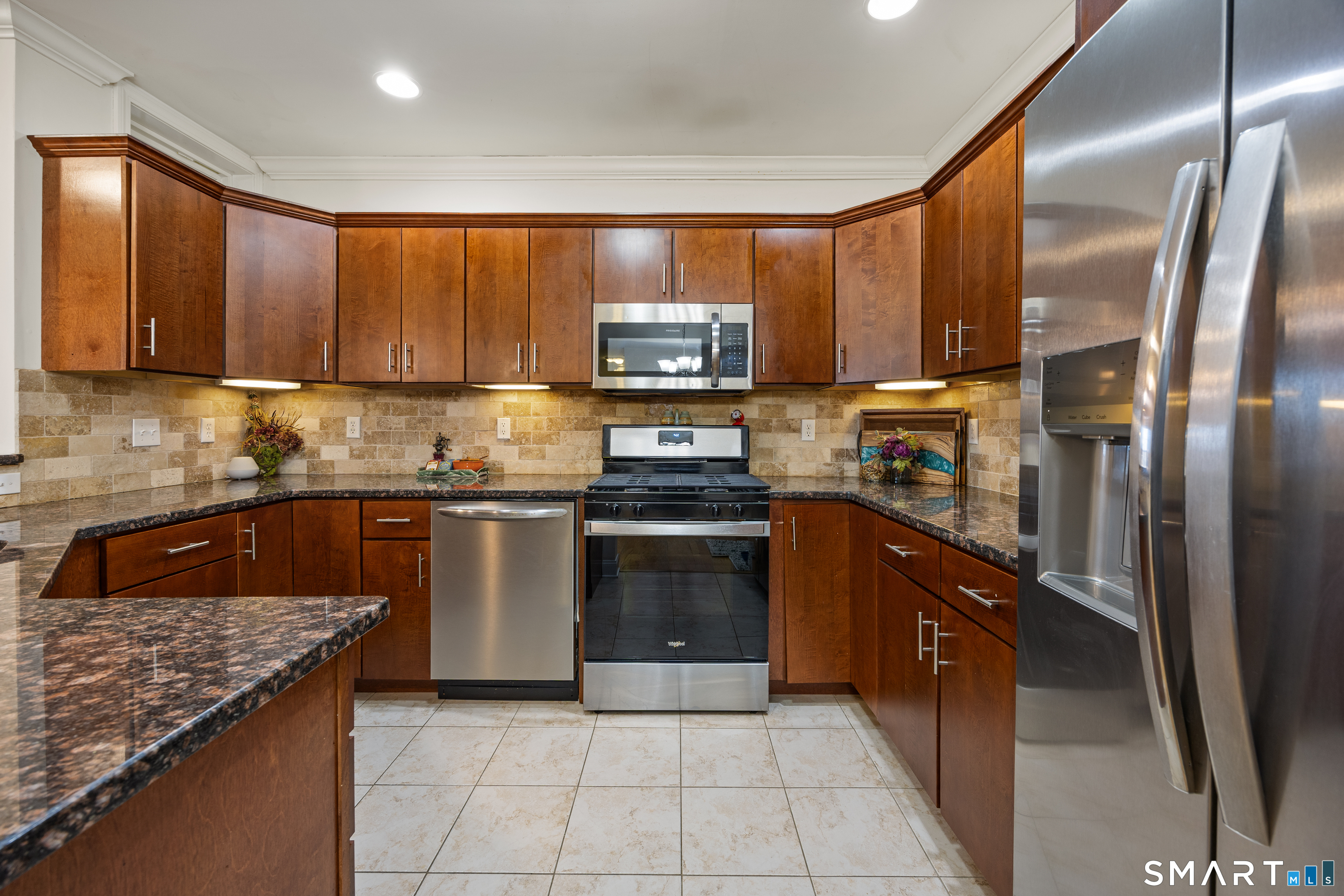95 South Ridge Lane, Unit FGL2 Berlin, CT 06037 - Photo 12 of 33 a kitchen with stainless steel appliances granite countertop a stove a sink and a refrigerator