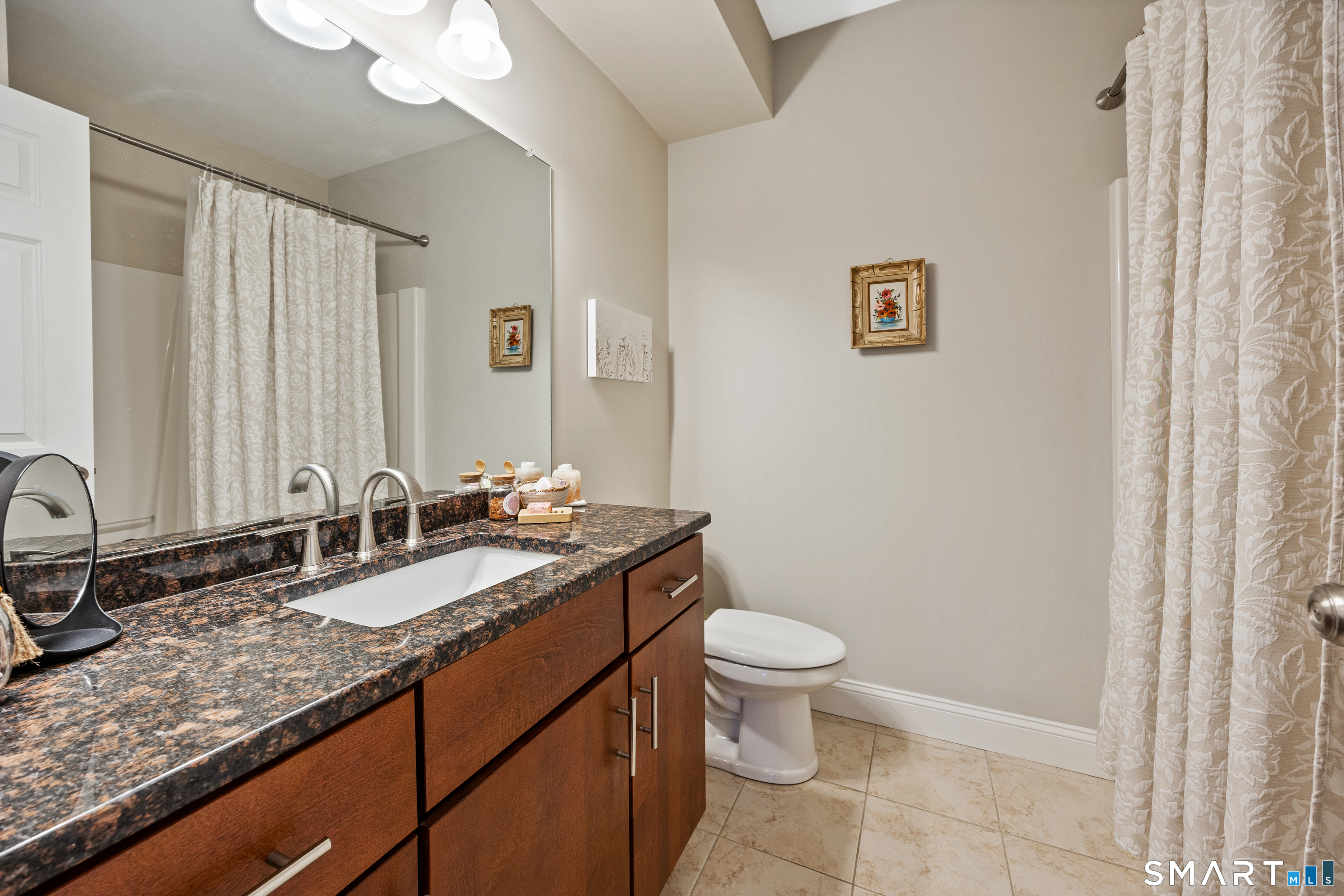 95 South Ridge Lane, Unit FGL2 Berlin, CT 06037 - Photo 18 of 33 a bathroom with a granite countertop sink a toilet and a mirror