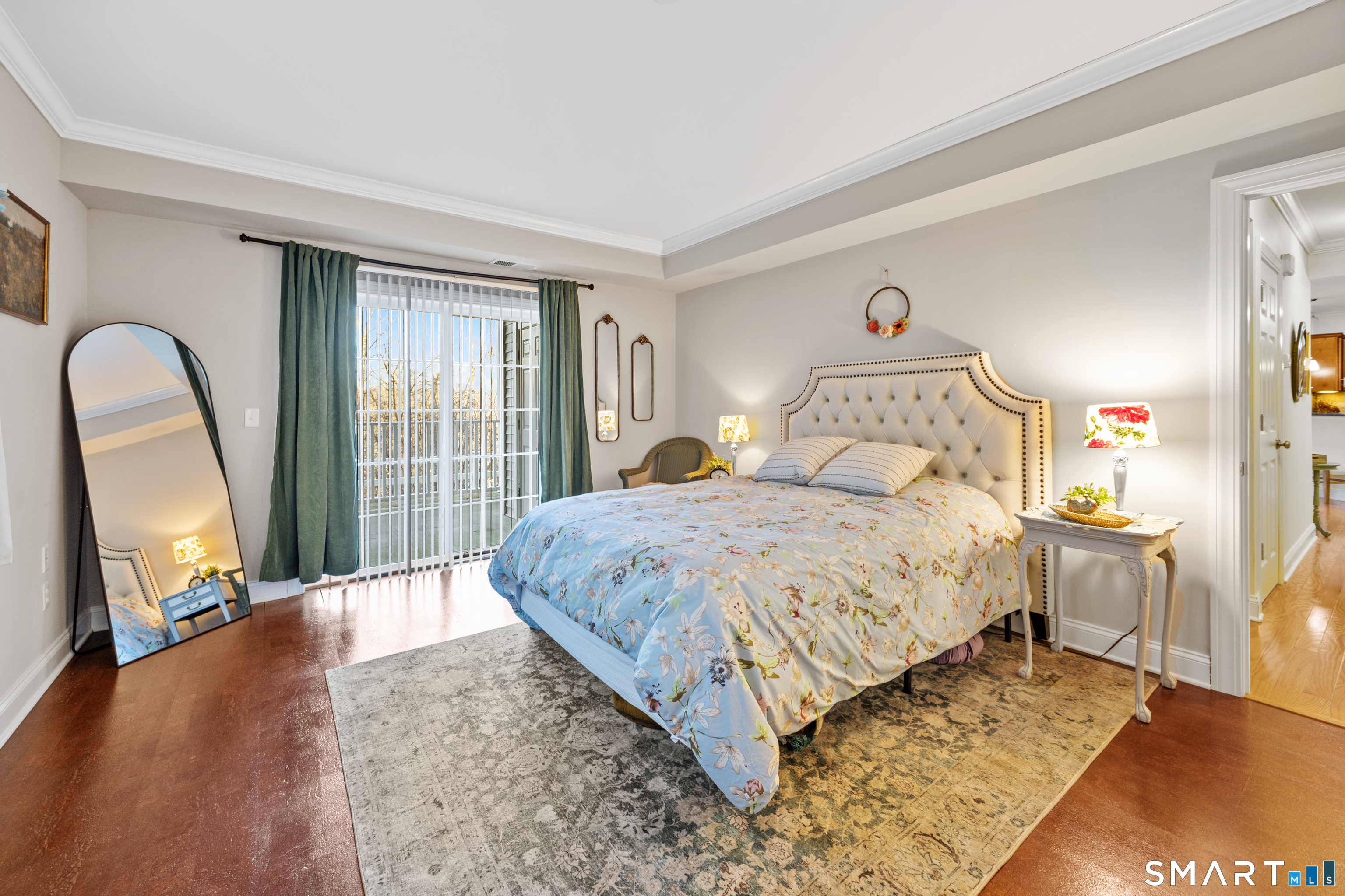 95 South Ridge Lane, Unit FGL2 Berlin, CT 06037 - Photo 20 of 33 a spacious bedroom with a bed a mirror and a large window with wooden floor