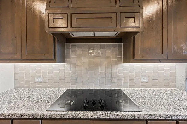a kitchen with a stove and cabinets