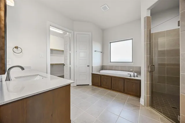 a bathroom with a bathtub sink and mirror
