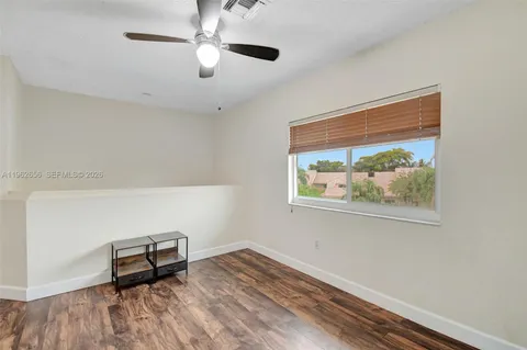 a bedroom with a bed window and a flat screen tv