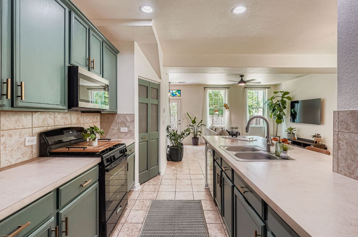 229 Ferrule Drive Kyle, TX 78640 - Photo 28 of 28 a kitchen with a sink stove and cabinets