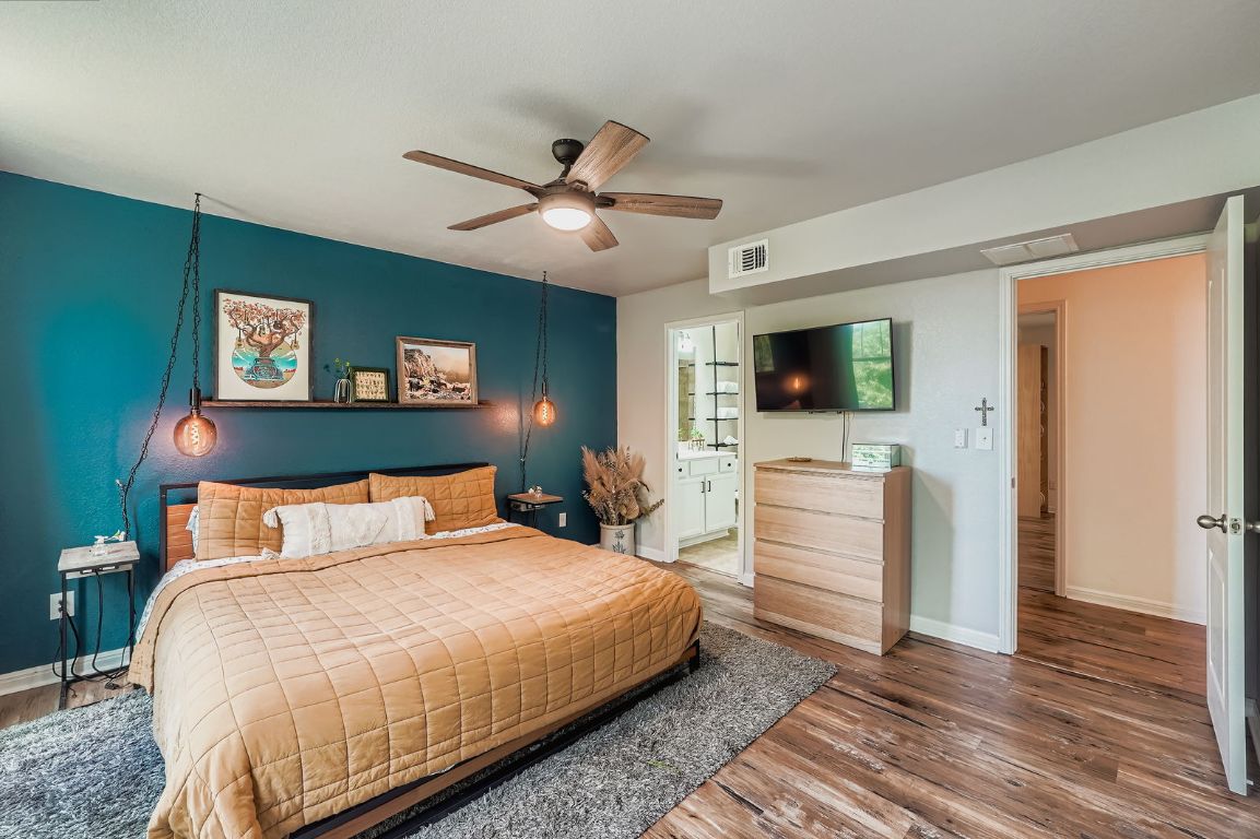 229 Ferrule Drive Kyle, TX 78640 - Photo 17 of 28 a bedroom with a bed and a flat screen tv