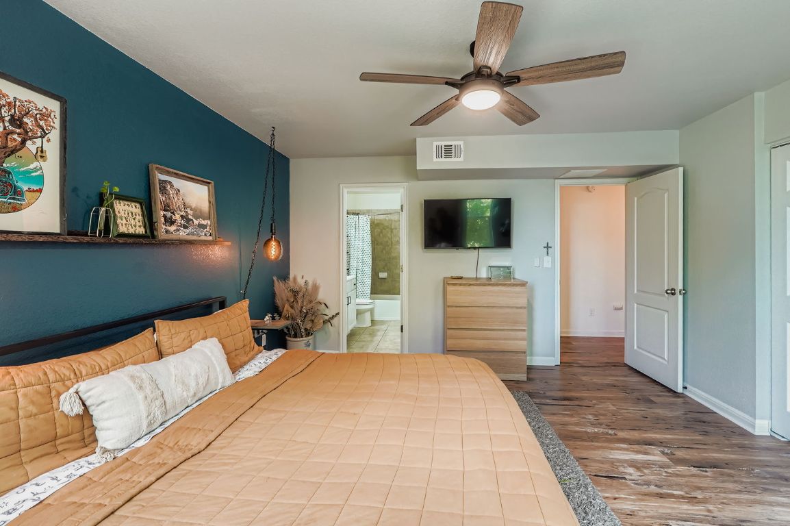 229 Ferrule Drive Kyle, TX 78640 - Photo 18 of 28 a bedroom with a bed and a flat screen tv