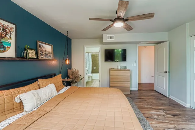 a bedroom with a bed and a flat screen tv