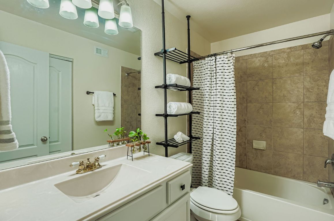 229 Ferrule Drive Kyle, TX 78640 - Photo 19 of 28 a bathroom with a sink toilet tub and shower