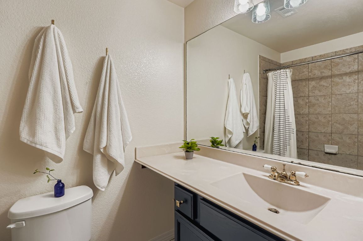 229 Ferrule Drive Kyle, TX 78640 - Photo 21 of 28 a bathroom with a double vanity sink and a mirror