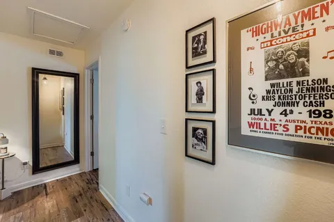 a view of a hallway with wooden floor and windows