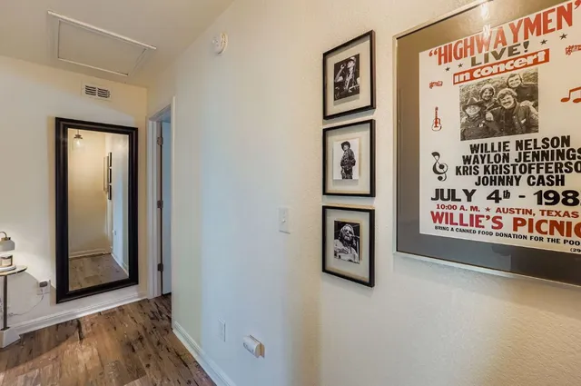 a view of a hallway with wooden floor and windows