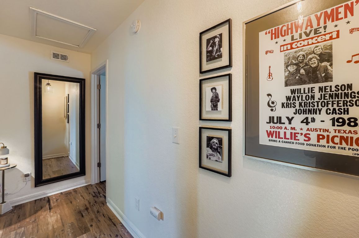 229 Ferrule Drive Kyle, TX 78640 - Photo 22 of 28 a view of a hallway with wooden floor and windows