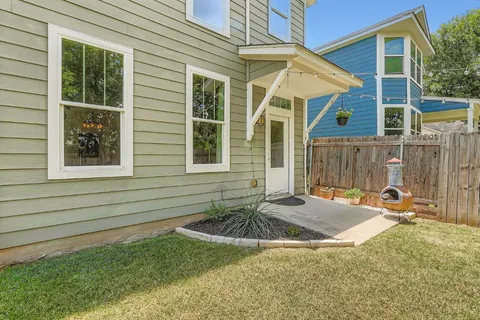 a backyard of a house with yard and outdoor seating
