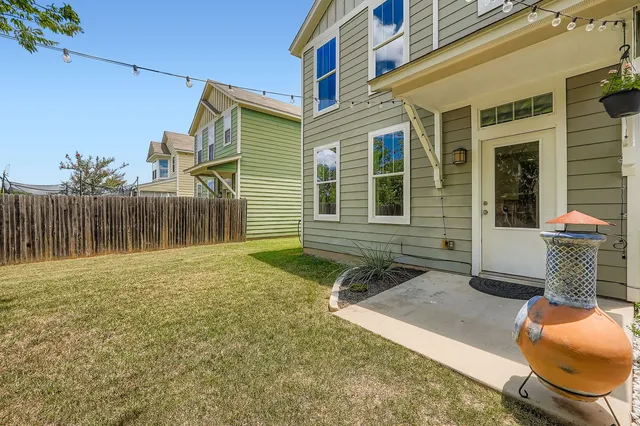 a backyard of a house with yard and outdoor seating