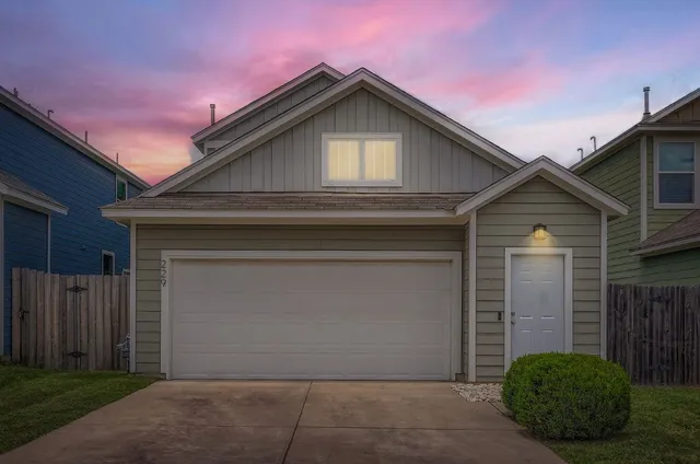 a front view of a house with garage