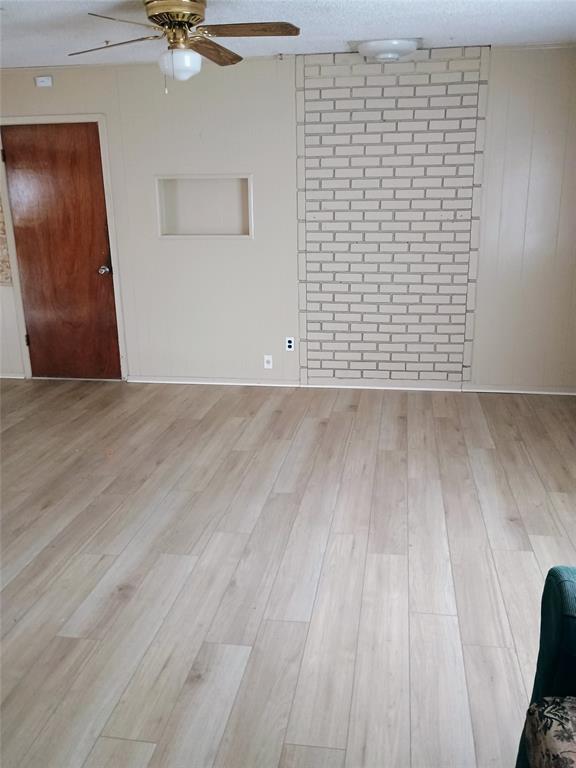 1303 East Boynton Hamilton, TX 76531 - Photo 11 of 21 a view of an empty room with wooden floor