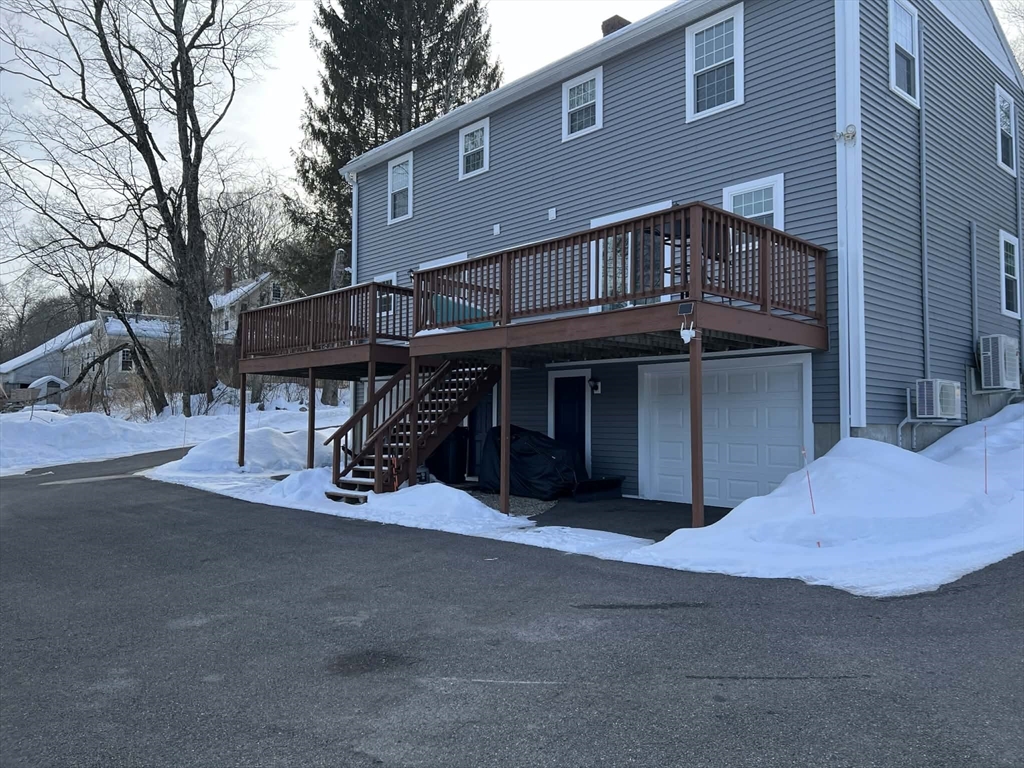313-315 Walnut Hill Road Orange, MA 01364 - Photo 3 of 19 a front view of a house with a garage