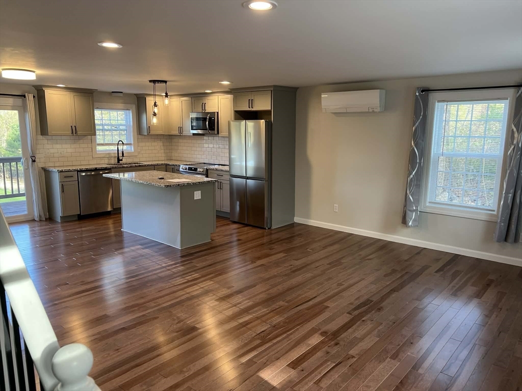 313-315 Walnut Hill Road Orange, MA 01364 - Photo 5 of 19 a kitchen with stainless steel appliances granite countertop a refrigerator a sink dishwasher a stove white countertops and wooden floor