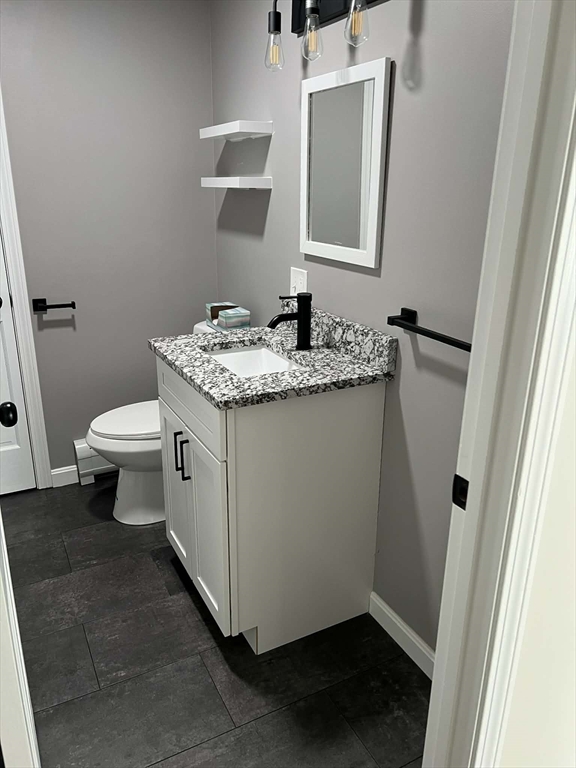 313-315 Walnut Hill Road Orange, MA 01364 - Photo 10 of 19 a bathroom with a granite countertop sink toilet and mirror