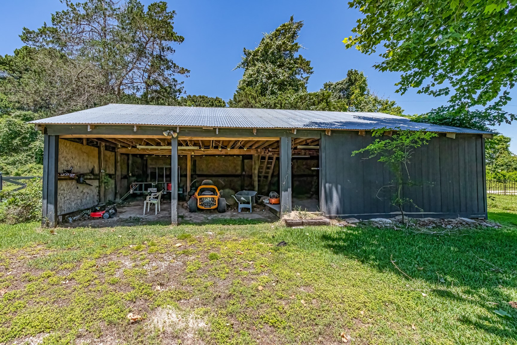 480 Johnson Road Coldspring, TX 77331 - Photo 10 of 49 2-car pole-style garage with a workshop and extra storage
