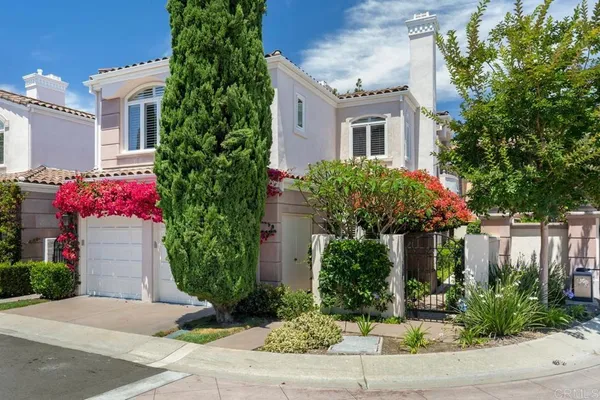 a garden with a table and chairs and potted plants