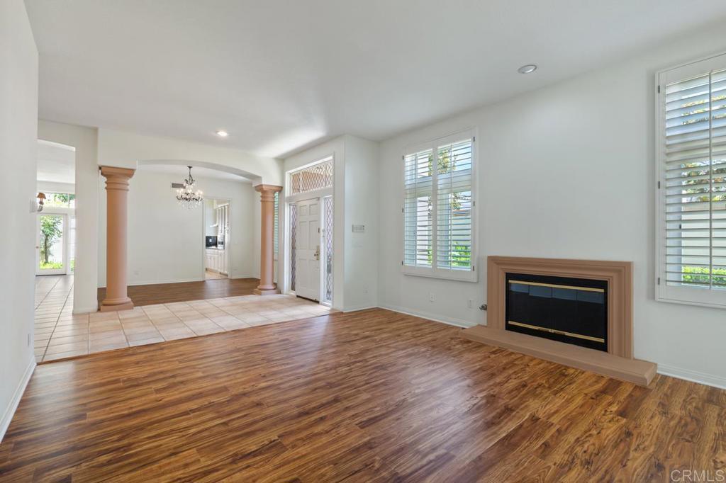 5402 Renaissance Avenue San Diego, CA 92122 - Photo 12 of 73 a view of an empty room with wooden floor fireplace and a window