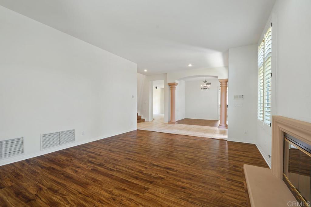5402 Renaissance Avenue San Diego, CA 92122 - Photo 13 of 73 a view of an empty room with wooden floor and a fireplace