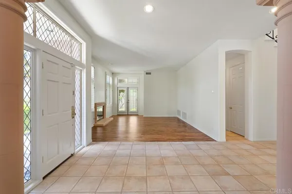 a view of a hallway with wooden floor and stairs