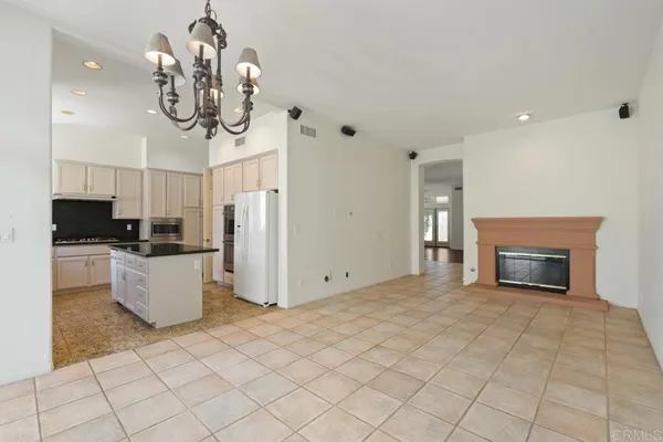 a view of empty room with window and wooden floor