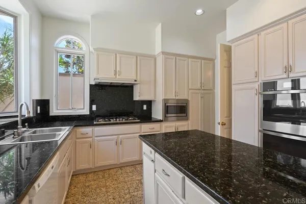a spacious bathroom with a granite countertop sink mirror and a