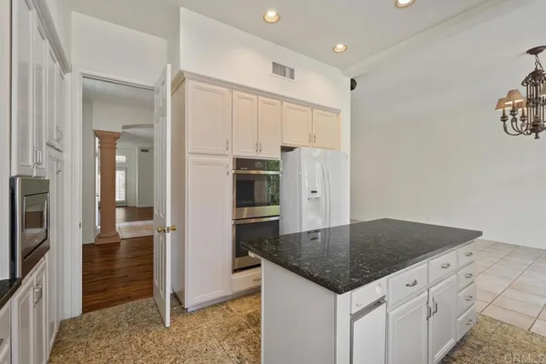 a view of walk in closet with wooden floor