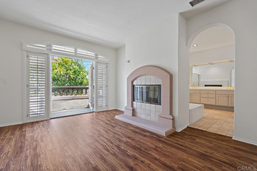 5402 Renaissance Avenue San Diego, CA 92122 - Photo 33 of 73 a view of empty room with wooden floor and fireplace