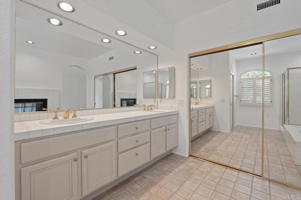 5402 Renaissance Avenue San Diego, CA 92122 - Photo 40 of 73 a spacious bathroom with a double vanity sink mirror and double