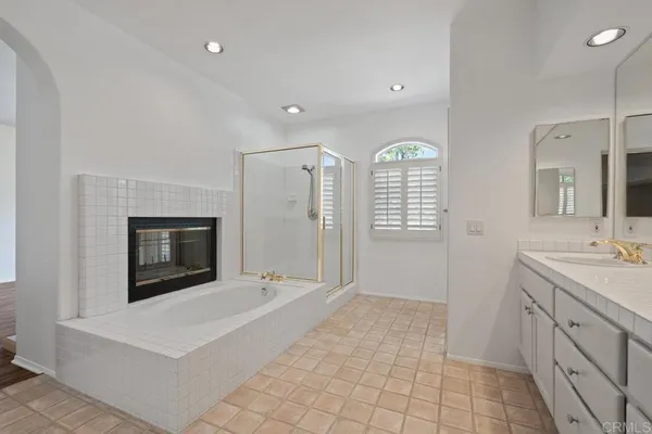 a bathroom with a granite countertop sink and a toilet