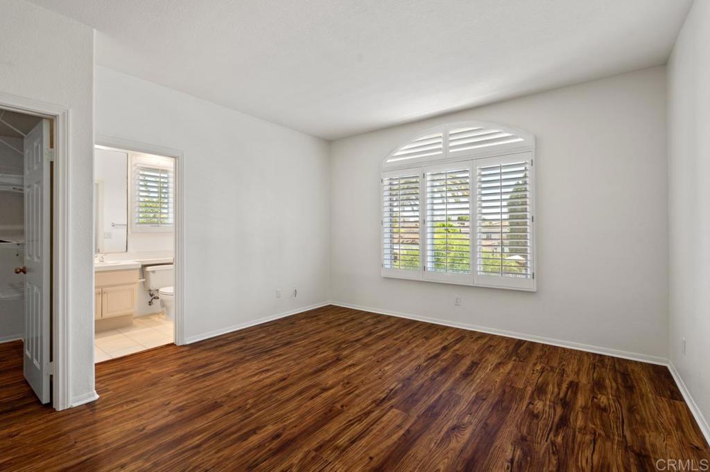 5402 Renaissance Avenue San Diego, CA 92122 - Photo 44 of 73 a view of an empty room with wooden floor and a window