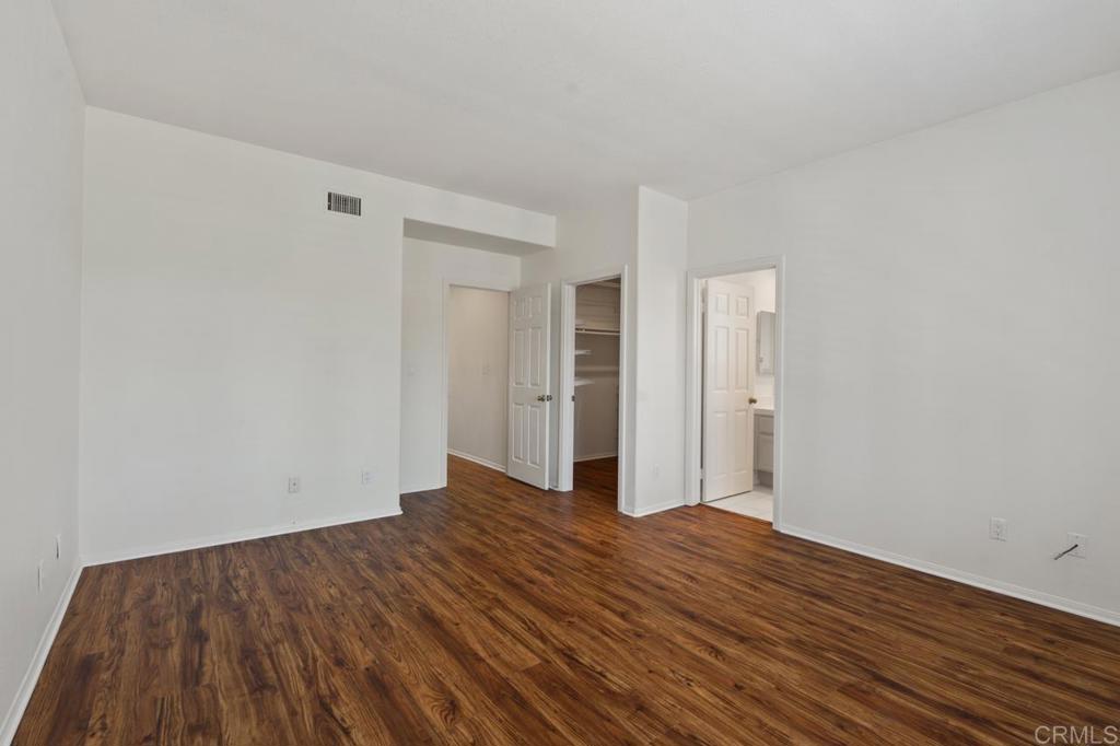 5402 Renaissance Avenue San Diego, CA 92122 - Photo 45 of 73 a view of an empty room with wooden floor and closet