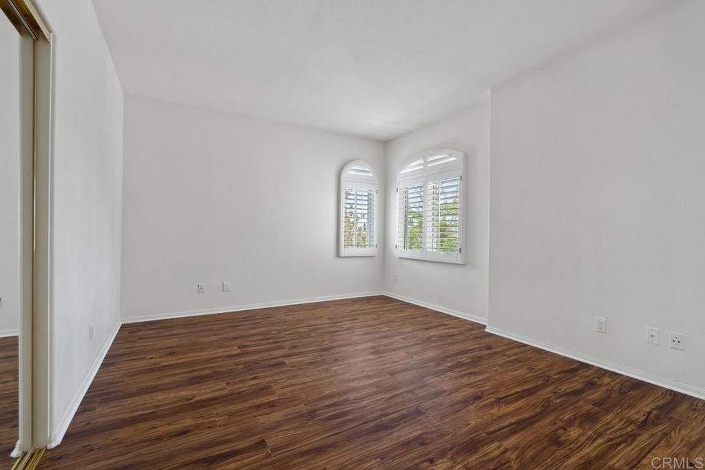 5402 Renaissance Avenue San Diego, CA 92122 - Photo 51 of 73 an empty room with wooden floor and windows