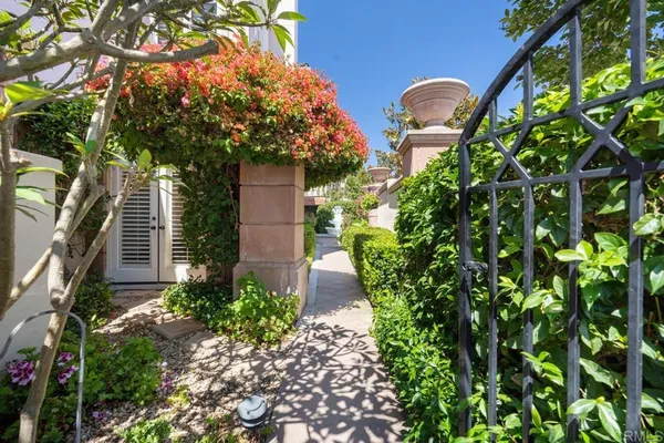 a view of an empty room with wooden floor fireplace and a window