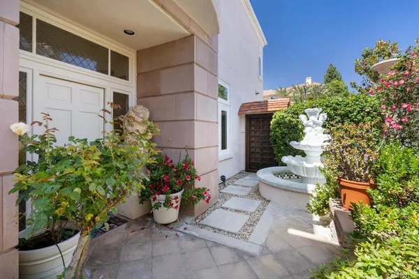 a view of an empty room with wooden floor and a fireplace
