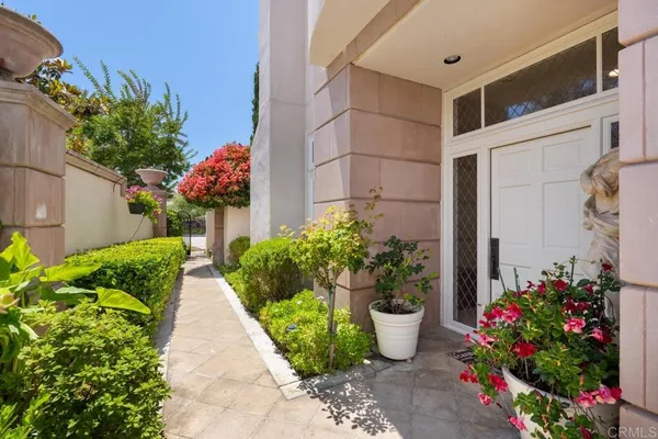 a view of an empty room with wooden floor and a fireplace