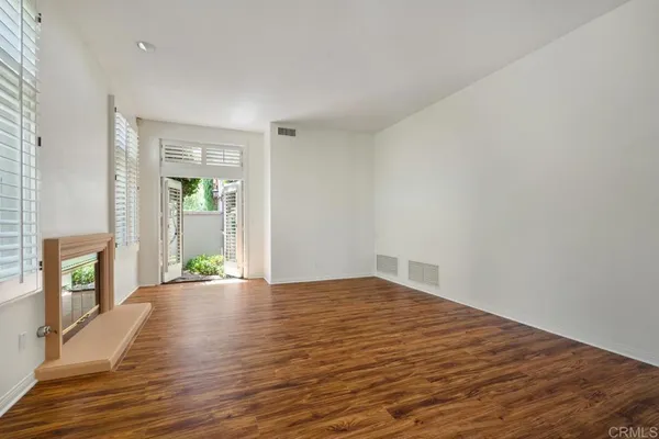 a view of a hallway with wooden floor and a chandelier