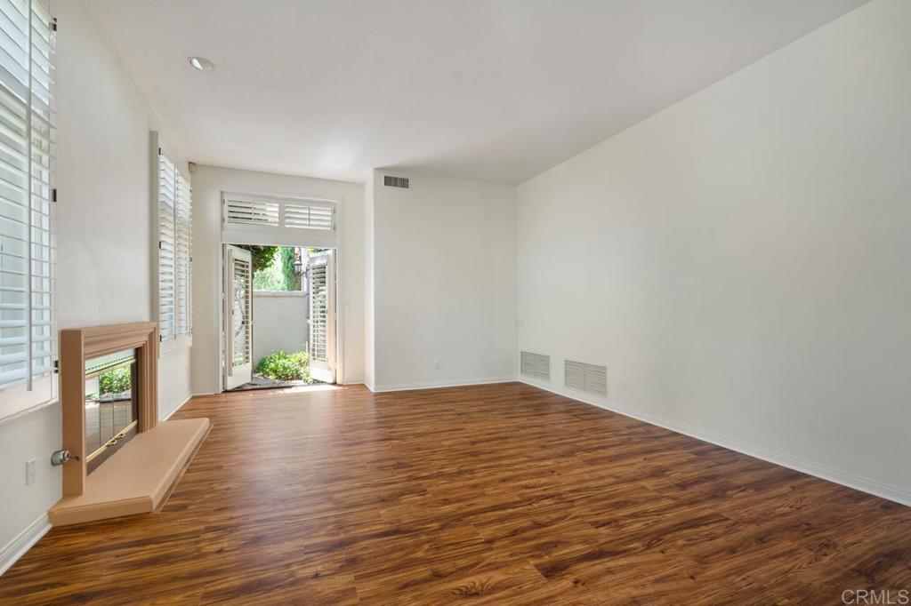 5402 Renaissance Avenue San Diego, CA 92122 - Photo 10 of 73 a view of an empty room with wooden floor and a window