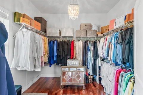 a view of walk in closet with clothes