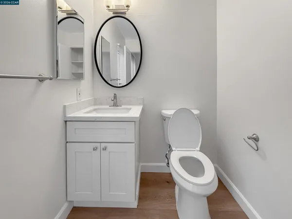 a bathroom with a toilet a sink and a mirror
