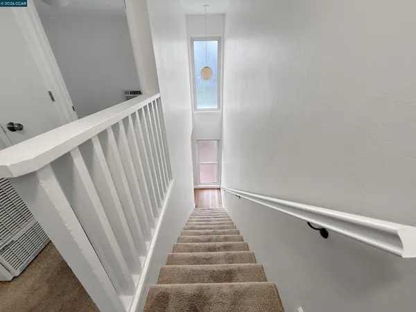 a view of a hallway view with staircase
