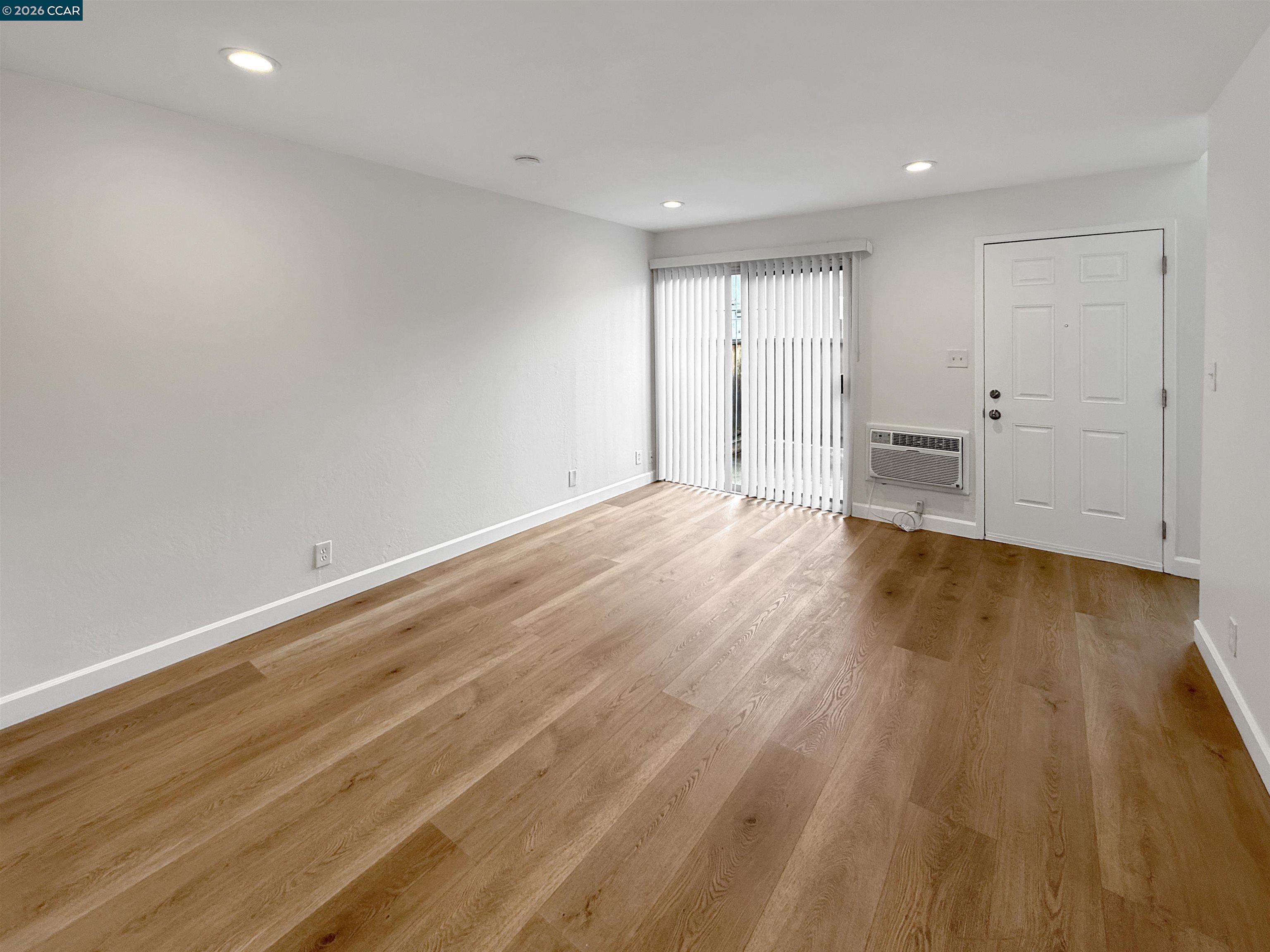 1919 Ygnacio Valley Road, Unit 55 Walnut Creek, CA 94598 - Photo 3 of 33 a view of an empty room with wooden floor