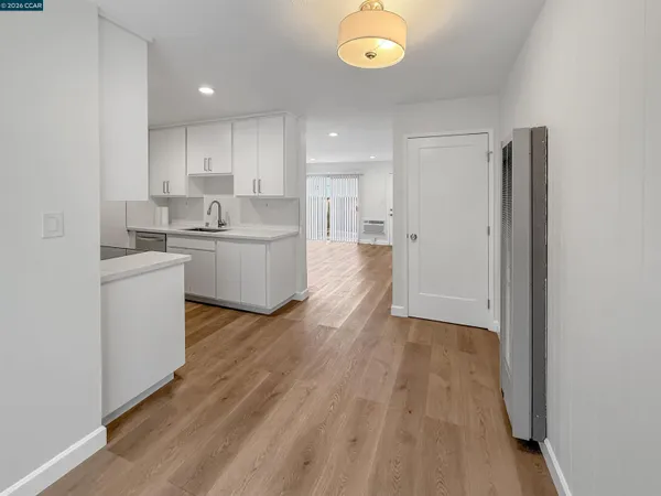 a kitchen with a sink and wooden floor