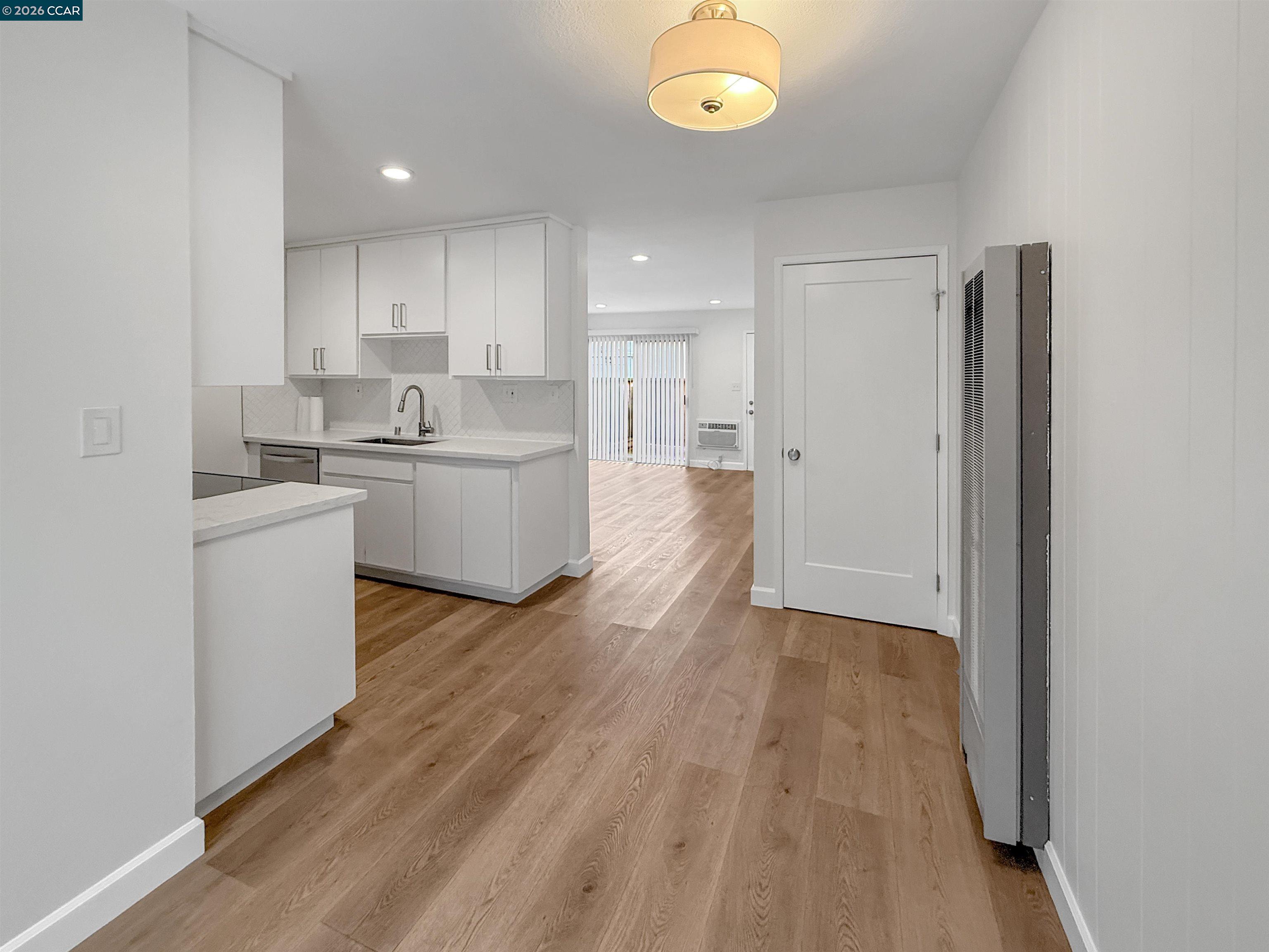 1919 Ygnacio Valley Road, Unit 55 Walnut Creek, CA 94598 - Photo 7 of 33 a kitchen with a sink and wooden floor