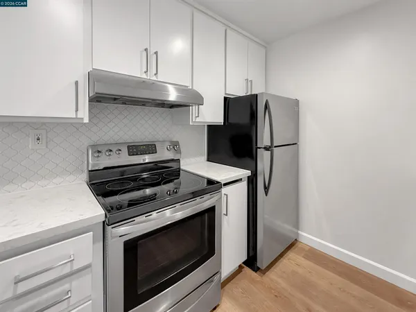 a kitchen with stainless steel appliances a stove microwave and refrigerator