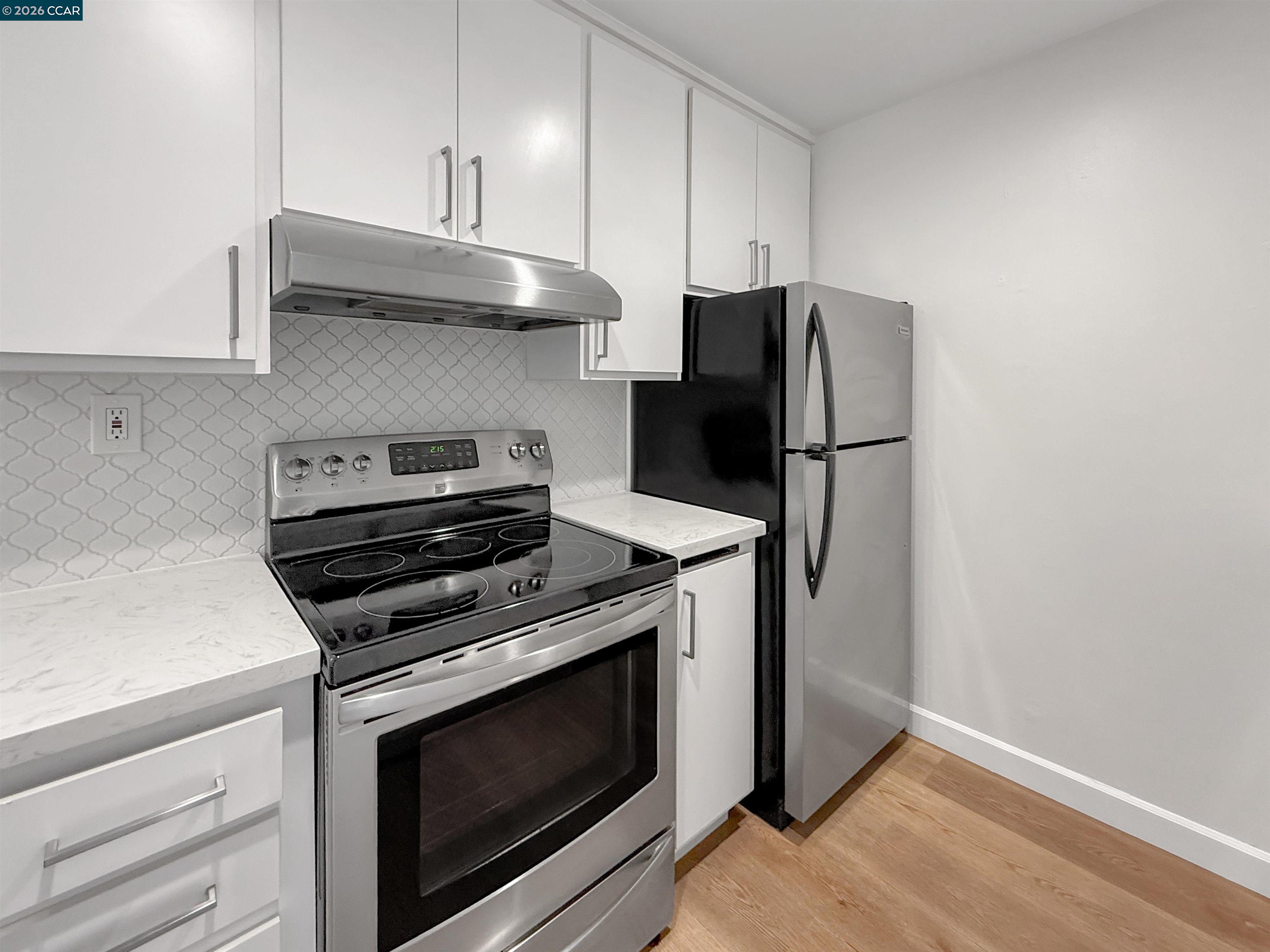 1919 Ygnacio Valley Road, Unit 55 Walnut Creek, CA 94598 - Photo 10 of 33 a kitchen with stainless steel appliances a stove microwave and refrigerator