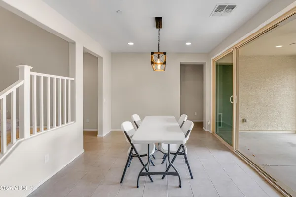 a kitchen with a table chairs sink and cabinets